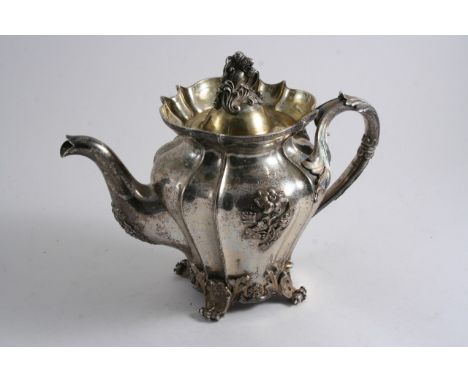 A MID 19TH CENTURY RUSSIAN PARCELGILT TEA POT with a naturalistic foliate scroll handle, foliate scroll feet & applied floral