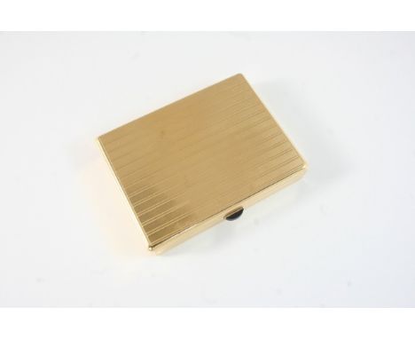 A GOLD CIGARETTE BOX BY CARTIER of rectangular shape, with engine turned decoration to both sides, the thumb piece set with a
