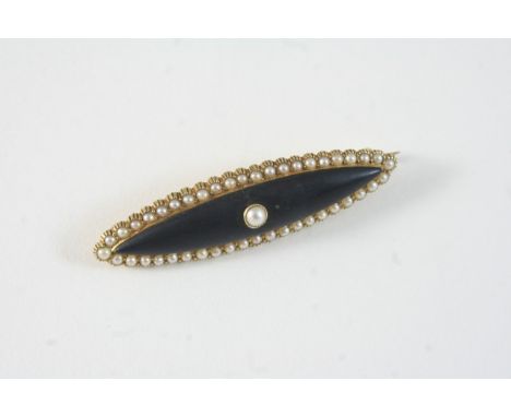 A BLACK ENAMEL AND PEARL BROOCH the central black enamel section is set with a pearl within a surround of pearls, in 15ct. go