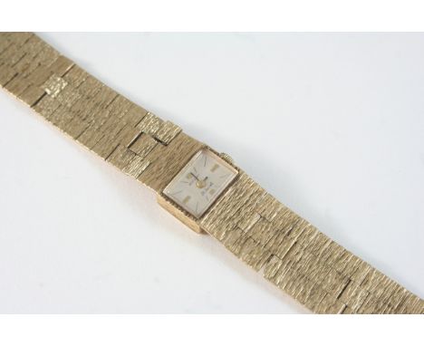 A LADY'S 9CT. GOLD WRISTWATCH BY ROTARY the signed rectangular-shaped dial with baton numerals, on an integrated textured gol