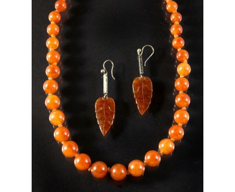 A SINGLE ROW GRADUATED ORANGE JADE BEAD NECKLACE the jade beads graduate from approximately 4.2mm. to 9.5mm., 80cm. long, tog