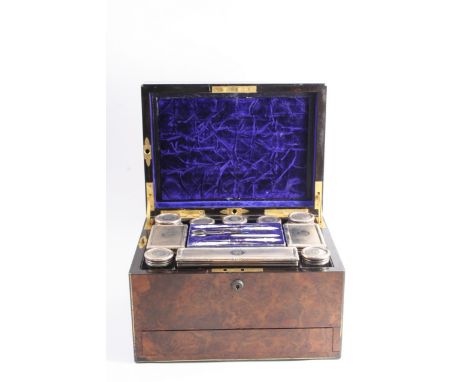 A VICTORIAN BRASS BOUND WALNUT DRESSING CASE fitted with ten mounted glass bottles/boxes/jars, each initialled "R", & a steel