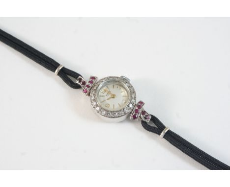 A LADY'S DIAMOND AND RUBY COCKTAIL WRISTWATCH BY BENSON the signed circular dial with Arabic quarters and baton numerals, wit