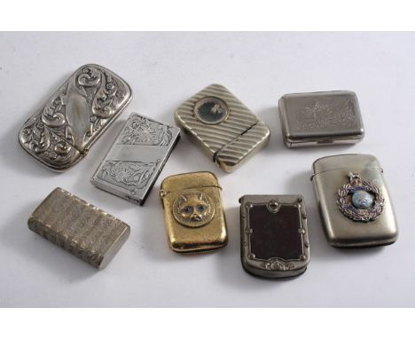 A LATE VICTORIAN BRASS  VESTA set with the portrait of a cat with red eyes, a nickel plated French example set with an applie