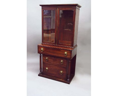 A GEORGE IV MAHOGANY SECRETAIRE the upper part enclosed by a pair of glazed doors, the projecting lower part with a pull-out 