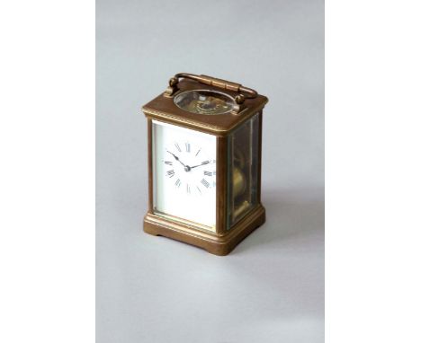 A CARRIAGE CLOCK dial white enamel, movement lever escapement, sriking on a gong, 5 1/2ins. (14cms.) high
