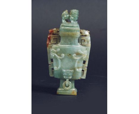 A JADE URN AND COVER of flattened baluster shape, the front carved in low relief with foliage,  5 1/2ins .(14cms.) high