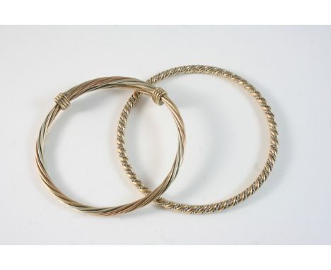 A 9CT. GOLD BANGLE together with another 9ct. bangle, total weight 46 grams.