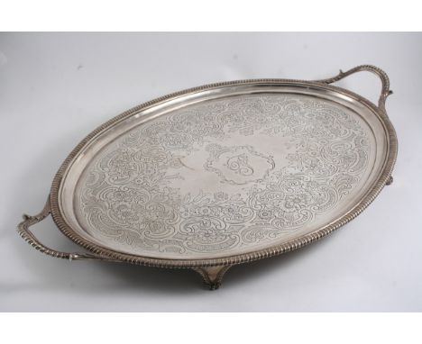 A GEORGE III TWO-HANDLED OVAL TRAY with gadrooning & bracket feet, later embossed decoration, initialled, by Thomas Hannam & 