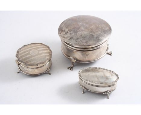 THREE DRESSING TABLE JEWEL BOXES a large plain circular example on three feet, Birmingham 1915, a small oval example with a s