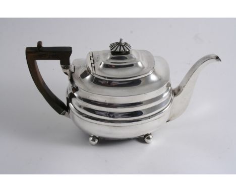A GEORGE III BARGE-SHAPED TEA POT on ball feet, with a fluted knop finial, probably by John Wakefield, London 1807;  6.25"  (