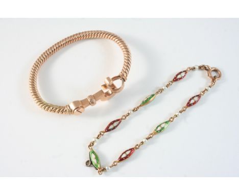 A GOLD BANGLE with ornate clasp, 16 grams, together with a green, red and white enamel bracelet, set with small pearls, 19.5c