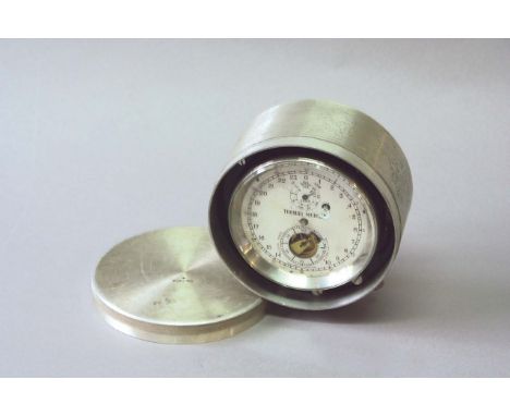 A MARINE CHRONOMETER by Thomas Mercer, exposed escapement, dated 1953, contained in an aluminium case, 6ins. (15cms.) dia. ov