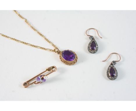 AN AMETHYST AND GOLD PENDANT set with an oval-shaped amethyst in gold mount, on a gold fine link chain, together with an enam