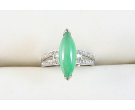 A JADE AND DIAMOND RING set with a marquise-shaped section of jade, with circular-cut diamonds, in white gold. Size L.