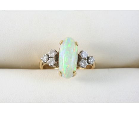 AN OPAL AND DIAMOND RING the oval cabochon white opal is set with three circular-cut shoulder diamonds, in platinum and 18ct.