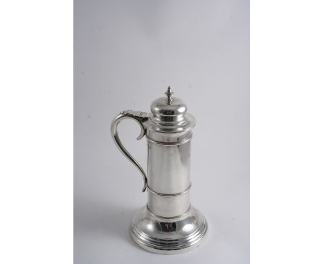 A CYLINCRICAL FLAGON on a spreading circular foot with a large scroll handle, domed cover & knop finial, inscribed around & u