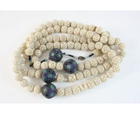 A 19TH CENTURY STRING OF CHINESE MANDARIN IVORY AND ENAMEL COURT BEADS formed with pierced and carved ivory beads, with ename