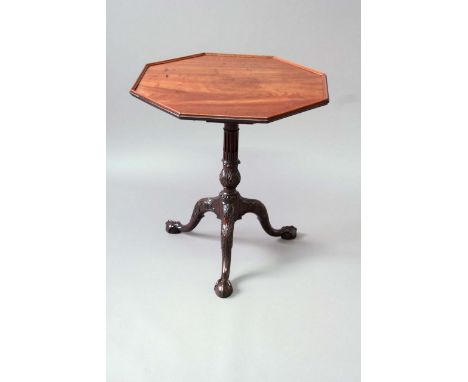 A GEORGE III MAHOGANY OCTAGONAL TRIPOD TABLE the top with an applied moulded edge, on a birdcage support, the fluted column o