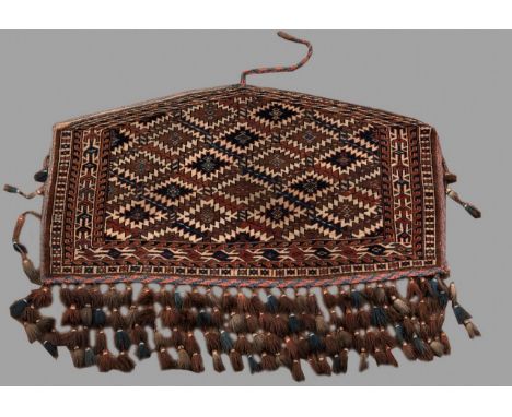 A YOMUD TURCOMAN JUVAL woven with a lozenge tile pattern, generally good, 2ft 2ins. (66cms.) x 3ft 9ins. (114cms.)
