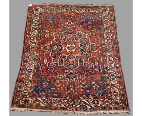 A WEST PERSIAN SMALL CARPET the brick field woven with floral tendrils and a blue medallion, fair, some mothing, 9ft 6ins. (2