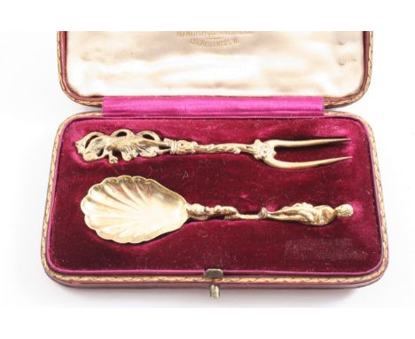 A LATE 19TH CENTURY CONTINENTAL SILVERGILT SMALL SPOON & a small two-pronged fork*, each with a figure finial (contained in a