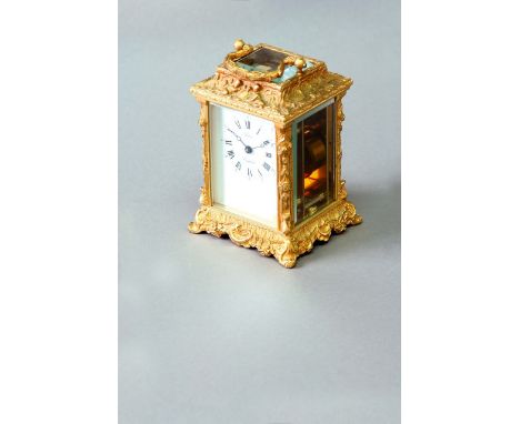 A CARRIAGE TIMEPIECE dial white enamel, signed Parkin, England, the ormolu case cast with putti and scrolls, 5 3/4ins. (14.5c