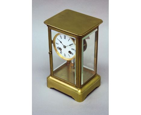 A FOUR GLASS MANTEL CLOCK dial white enamel, movement drum, with mercury pendulum striking on a bell, 9 1/2ins. (24cms.) high