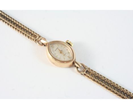 A LADY'S 9CT. GOLD WRISTWATCH BY ROTARY the signed navette-shaped dial with two Arabic and with baton numerals, on a gold bra