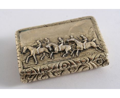 A GEORGE IV SILVERGILT OBLONG SNUFF BOX with an engraved base, embossed convex sides & a horse racing scene in relief on the 
