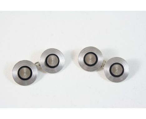 A PAIR OF 18CT. WHITE GOLD CUFFLINKS BY LONGMIRE of circular form, each engine turned link set with a circle of black enamel,