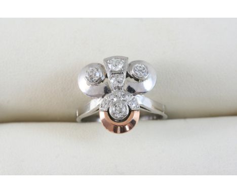 A DIAMOND CLUSTER RING of trefoil design, set with graduated circular-cut diamonds, in white gold. Size K 1/2.