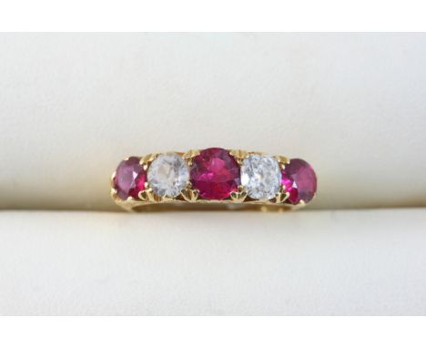 A RUBY, DIAMOND AND ZIRCON FIVE STONE RING set with three graduated circular-cut rubies, a cushion-shaped diamond and a circu