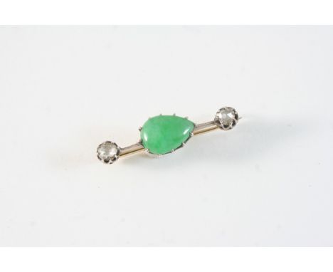 A JADE AND DIAMOND BROOCH the pear-shaped green jade cabochon is set with two rose-cut diamonds, in gold, 3.5cm. long.