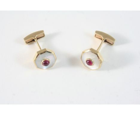 A PAIR OF MOTHER-OF-PEARL AND RUBY CUFFLINKS each octagonal mother-of-pearl link centred with a cabochon ruby, in 9ct. gold, 