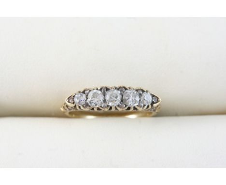 A DIAMOND FIVE STONE RING set with five graduated circular-cut diamonds, with rose-cut diamond highlights, in 18ct. gold. Siz