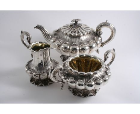 A GEORGE IV / WILLIAM IV THREE-PIECE TEA SET of melon fluted form with matted decoration around the bodies & bases, scroll ha