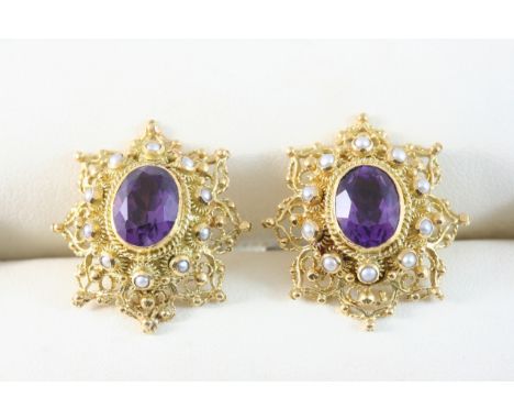 A PAIR OF AMETHYST AND GOLD STUD EARRINGS each set with an oval-shaped amethyst within a surround of small pearls, in gold fi