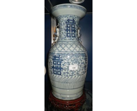 A CHINESE BLUE AND WHITE VASE with all over hand painted decoration, 17" high, with hardwood stand