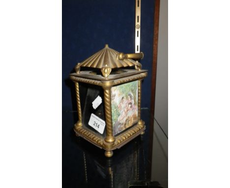 A 19TH CENTURY CONTINENTAL GILT METAL NIGHT LIGHT with coloured glass panels, one side relief decorated 