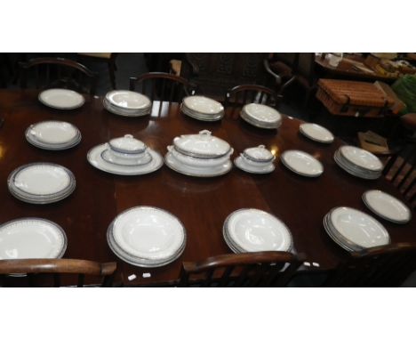 A ROYAL WORCESTER BLUE AND GILT BANDED DINNER SERVICE