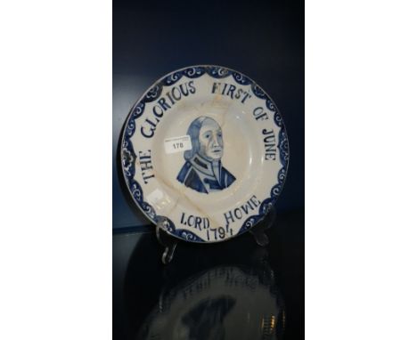 AN 18TH CENTURY TIN-GLAZED DELFT PLATE 'The Glorious First of June, Lord Howe, 1794' bearing a portrait of Lord Howe (examine