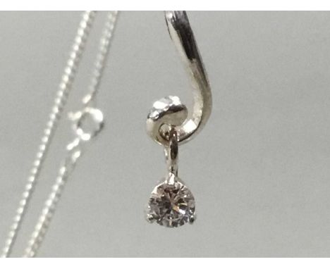 ELEVEN VINTAGE SILVER PENDANTS AND CHAINS