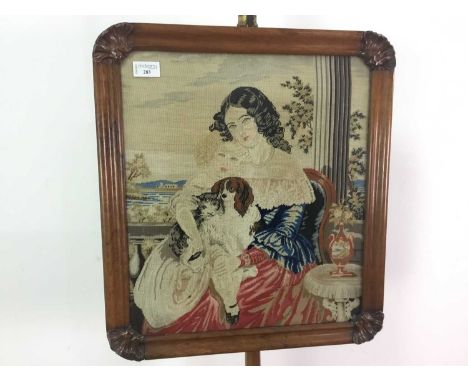 LATE 19TH/EARLY 20TH CENTURY FIRE SCREEN,decorated with a needlework figural scene depicting a lady sat on a balcony with two