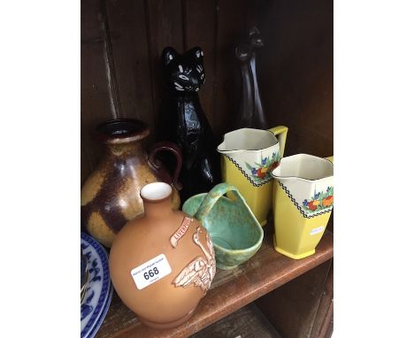 A shelf of misc pottery including cat, birds, etc 