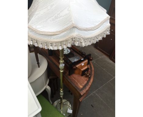 A brass and onyx effect standard lamp 