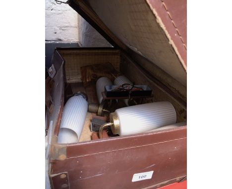 A vintage case with contents, some wall lights. 