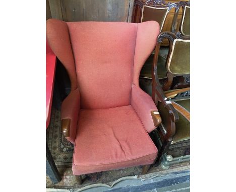 A retro Parker Knoll armchair with wing back and show wood arms, width 77cm, depth 92cm & height 98cm.(This item may not comp