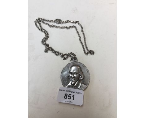 A white metal chain having pendant bearing William Shakespeare portrait. 
