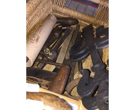A basket of vintage tools, many made of ebony and brass. 